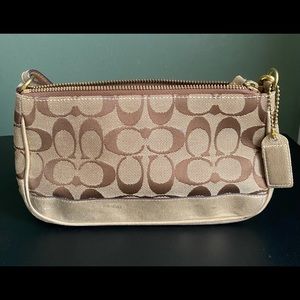 Authentic Coach signature Demi Pouch in gold. Great condition, hardly used.